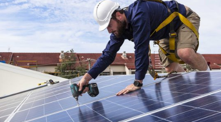 Solar panel installer at work.